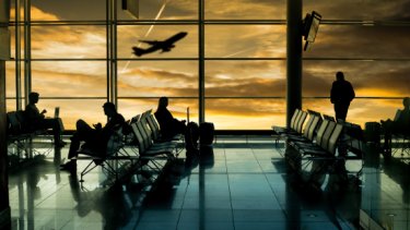 silhouette of airport passengers and airplane taking off in an airport