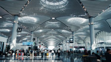APS blog image of an airport aisle with crowd